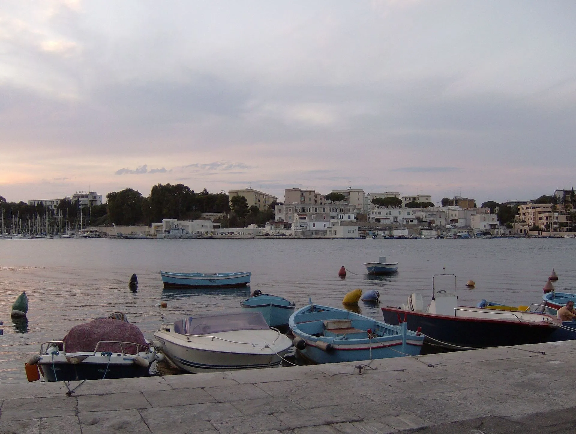 Panoramic view of Brindisi harbor with boats and the city waterfront