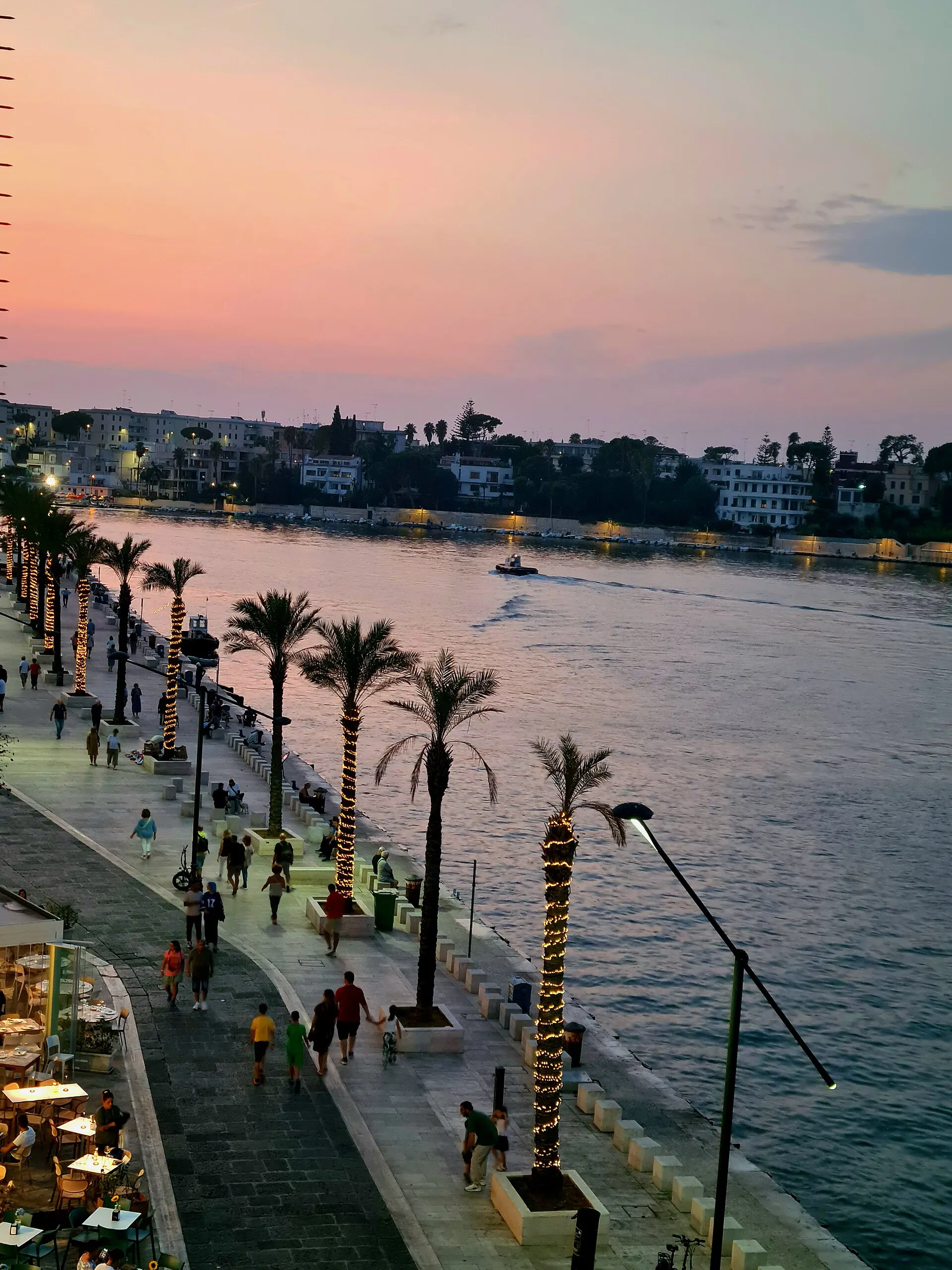Golden sunset over the Brindisi waterfront promenade
